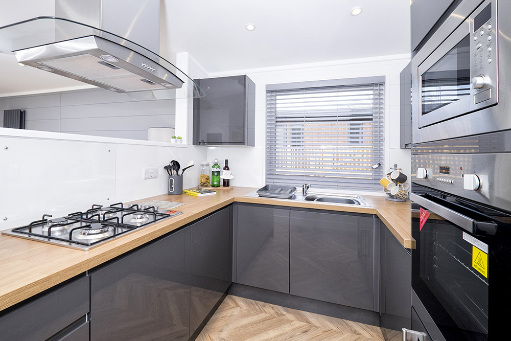 Bright and airy open plan kitchen in greys and wood finish